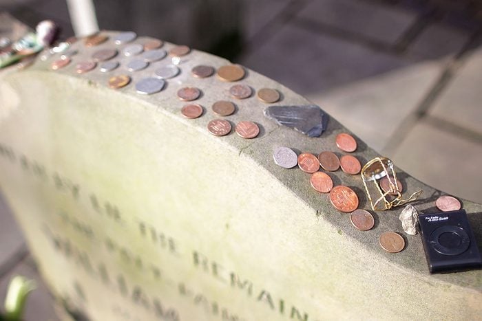 Coins are left on top of the headstone and memorial for the poet and painter William Blake in the Bunhill Fields cemetery, which has been awarded Grade 1 listed status on February 24, 2011 in Islington, London, England.