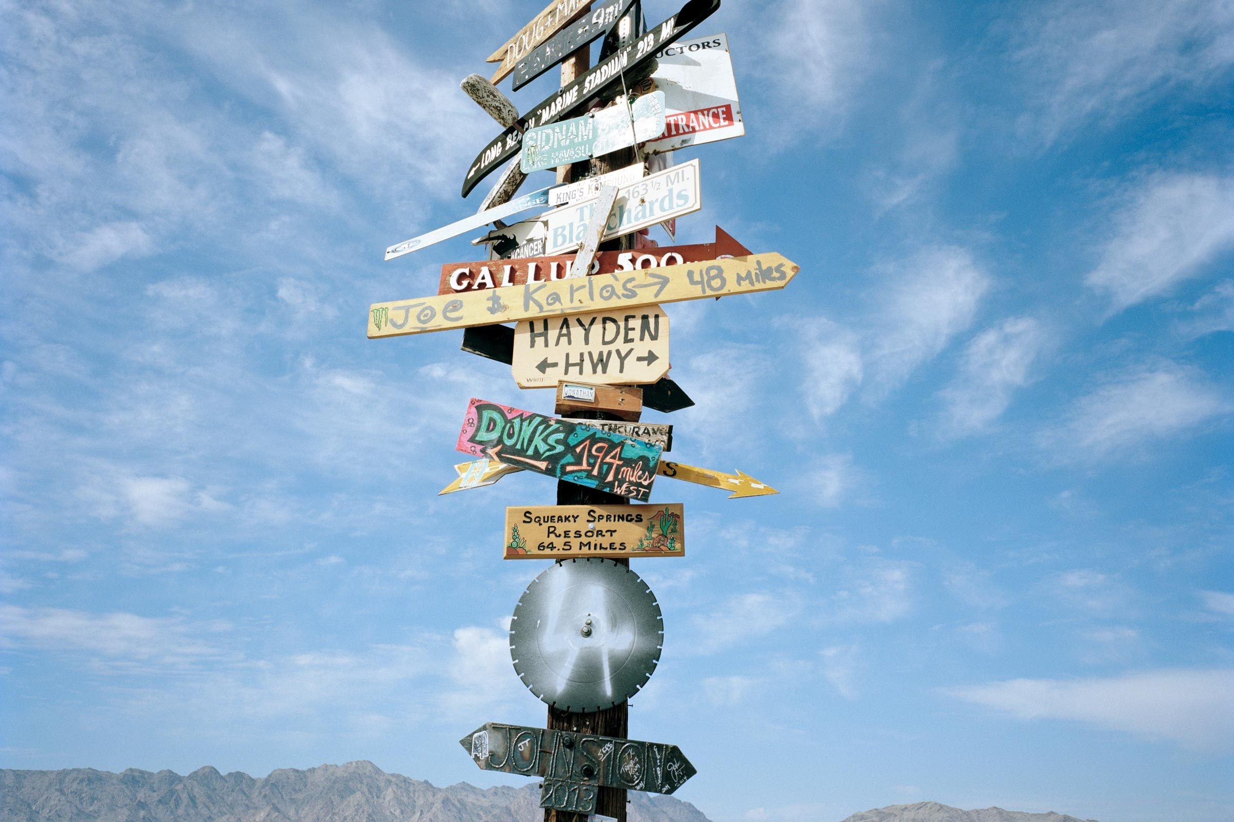 signpost with many signs in the mojave desert, nevada, usa